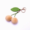 Cute cherry plush keychain with beige faux fur balls and green leaf in golden ring - Beige