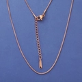 Detail of rose gold snake chain necklace with lobster clasp and S-STEEL tag on blue base - 1.5mm 45+5cm / Rose Gold