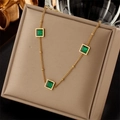 Elegant gold titanium necklace with three square emerald zircons on a beige display pad - Green Square Gemstone Decorated Style (N1740)