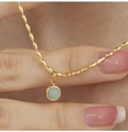 Close-up of 18K gold plated necklace with round green aventurine pendant on skin - Gold