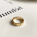 Macro detail of gold-plated textured open ring with inlaid rectangular cubic zirconia - Textured Pave