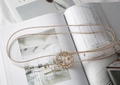 Detail of a thin transparent belt featuring a sparkling rhinestone sunflower buckle - Round Rhinestone Transparent (Gold Beaded Edge)
