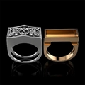Detailed front view of silver and gold punk skull rings with intricate 3D carvings - US 7 / Gold + Silver