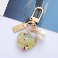 Detail of yellow resin heart keychain with glitter, pearl bead and Eternal Love tag - Lemon Yellow