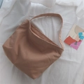 Close-up of khaki canvas tote bag showing weave texture and minimalist shoulder strap - Flesh Pink