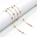 Golden eyewear chain with pearls and heart pendants on a minimalist white display - Gold Pearl Heart