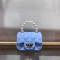 Close-up of mini blue jelly bag with quilted pattern, pearl handle and gold twist lock - Light Blue
