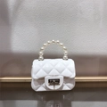 Detail of white quilted mini jelly bag featuring a glossy PVC finish and pearl handle - White