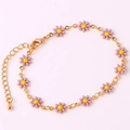 Detail of 18K gold bracelet featuring delicate purple and yellow enamel daisy charms - Purple Bracelet