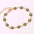 Detail view of 18K gold chain bracelet with green and yellow enamel daisy flower charms - Green Bracelet