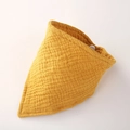 Detail of yellow cotton muslin baby bib showing soft gauze texture and snap button - Ginger Yellow