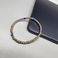 18K gold-plated beaded bracelet featuring a blue evil eye bead and gold beads - Blue Eye - Gold