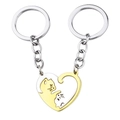 Detail of silver and gold heart pendant set featuring hollow cat yin yang design - Keychain Set (Gold & Silver Cat)