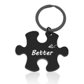 Detail of a matte black puzzle-shaped stainless steel keychain with Better text and paper plane - Better Black Keychain / Black