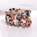 Macro shot of square acetate hair claw clip featuring colorful marble floral patterns - Multicolor Pattern