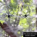 White stretchable Halloween spider web decoration on tree branches with two small black spiders - 20g Web + 2 Spiders / White