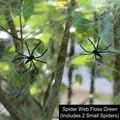 Detailed view of green spider web cotton with two small plastic spiders on tree branches - 20g Web + 2 Spiders / Green