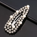 Macro shot of rectangular black hair clip with silver studs and white pearl accents - White & Silver Beads