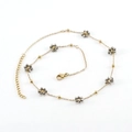 Minimalist gold chain necklace featuring crystal flower charms and faceted gray beads - White K Color - Necklace