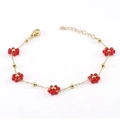 Elegant gold chain bracelet with red crystal flowers on a clean white background - Red Bracelet