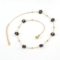 Golden stainless steel anklet featuring multiple woven black bead flower charms - Black Necklace