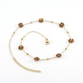 Gold stainless steel bracelet featuring brown crystal flowers on a white background - Bronze Necklace