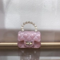 Detailed view of pink glitter jelly bag with quilted pattern and elegant pearl handle - Glitter