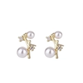 Elegant gold twig stud earrings with white pearls and sparkling cubic zirconia accents - Gold