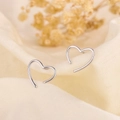Minimalist S925 sterling silver hollow heart stud earrings on beige linen background - Open Heart Stud Earrings