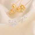 Elegant hollow butterfly bow stud earrings in silver finish with heart cutout details - Silver