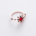 Macro shot of rose gold flower ring featuring a square red stone and blue crystal accents - 3#12951A (Red) Fixed Size