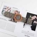 Macro detail of geometric weave straw belt with a large round wooden buckle - Round Buckle Mixed Color
