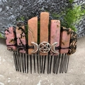 Detailed view of handmade pink crystal hair comb with silver crescent moon on moss rock - Rhodochrosite Black Wire Silver Moon