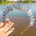 Detailed macro view of the metal crescent moon on a crystal crown with wire wrapping - Grey Blue