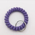 Macro detail of purple spiral wristband keyring with polished silver metal ring - Light Purple