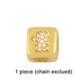 Detailed macro view of a gold-plated cube bead with a girl silhouette and zircon inlay - Boy / Gold Cube