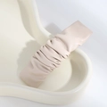 Detail of a beige pleated PU leather hair clip placed on a white ceramic tray - Wrinkled / Pleated White