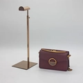 Detail of rose gold metal handbag stand with adjustable height and stable square base - D-Shape / Rose Gold