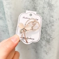 Détail d'une broche tulipe avec pierre œil de chat rose et strass sur carte bijou - A7-41-Ligne de Flux de Fleur Œil de Chat en Or