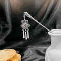 Detailed macro view of silver hollow flower hair pin with turquoise tassels and engraving - Silver/F236/Hollow Flower Triple Tassel