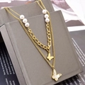 Collar de doble capa en titanio dorado con perlas y colgante de mariposa blanca - Dorado