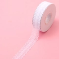 Detailed view of white scalloped lace ribbon roll for flower bouquet and gift wrapping - One Roll / White