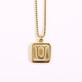 Minimalist gold square pendant necklace featuring letter U on a classic box chain - Letter U