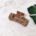 Detailed view of a large rectangular acetate claw clip with brown and blue marble pattern - Coffee Floral (Large)