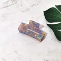 Macro view of a colorful marble-patterned acetate hair claw clip on marble background - Purple Floral (Medium)
