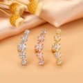Close-up of star shaped cartilage earrings with zircon stones in silver, gold and rose gold - Style 9