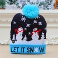 Detail of blue knitted Christmas hat with LED lights, snowman pattern and Let It Snow text - Sky Blue Snowman