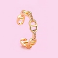 Macro shot of gold D-chain ear cuff with micro-pave pink zircon stones on pink backdrop - Anchor Chain Style(A2110) / KC Gold