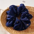 Detail of navy chiffon scrunchie with golden star patterns in a woven basket - Star Navy Blue