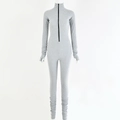 Detail of grey slim fit bodysuit with front zipper, thumbhole cuffs, and stacked legs - S / Gray